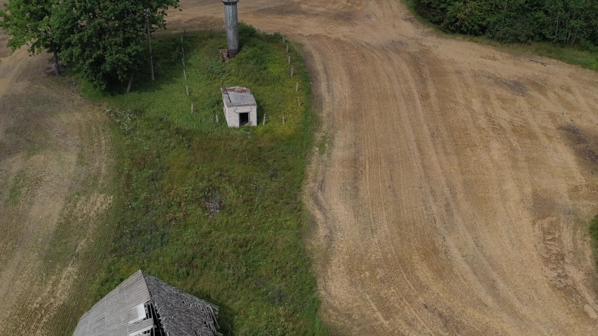 derelict homestead farm house ruins on agriculture field, aerial view