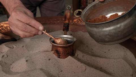 Turkish coffee making video. Turkish coffee brewing process in the sand and elderflower syrup.