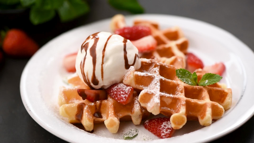 Belgian waffles with ice cream. Fork take bite of ice cream Royalty-Free Stock Footage #1040194085