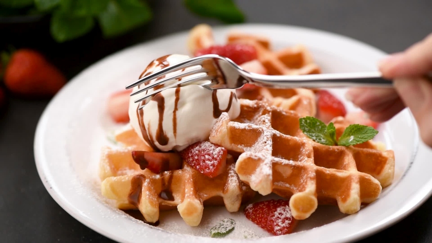 Belgian waffles with ice cream. Fork take bite of ice cream | Shutterstock HD Video #1040194085