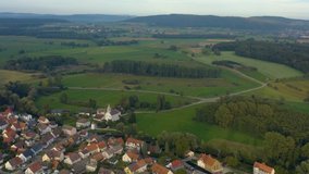 Aerial view of the city  Beuren an der Aach in Germany. On a sunny day in summer. Pan to the left around the church.