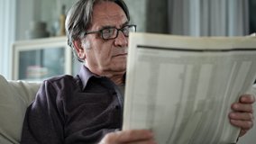 Senior man reading newspaper at home - Powered by Shutterstock - Get 15% off with code: PIKWIZARD15
