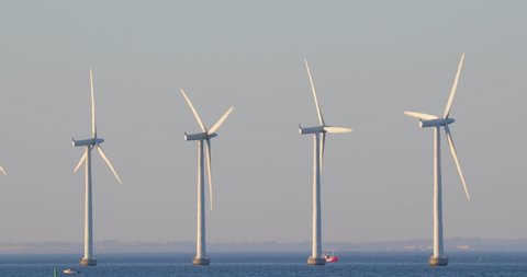 Offshore wind turbines at the sea with strong heat haze in the air in Copenhagen, Denmark