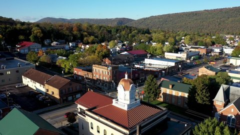 Pull back aerial view of the courthouse in the city of Romney in Hampshire County, West Virginia in autumn.
