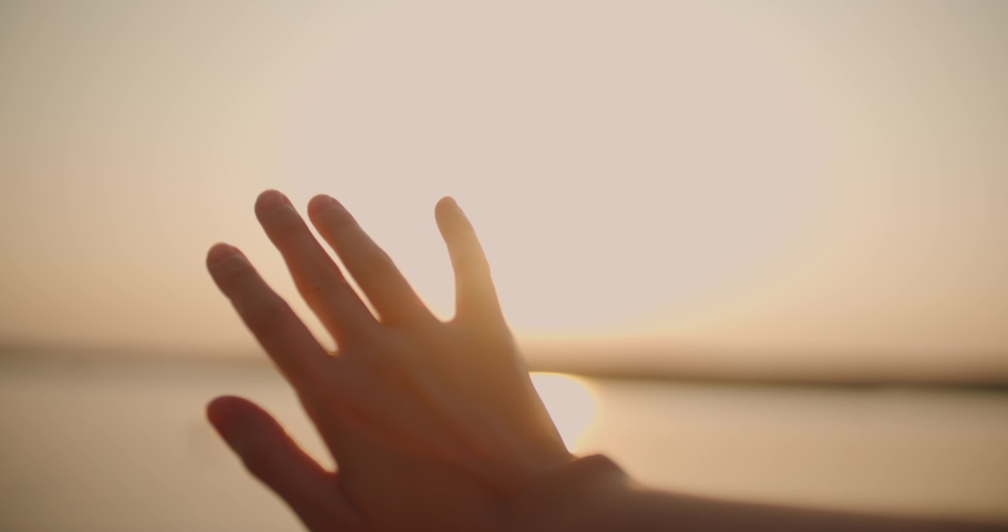 Female hand raising up to the sun-close | Shutterstock HD Video #1040222552