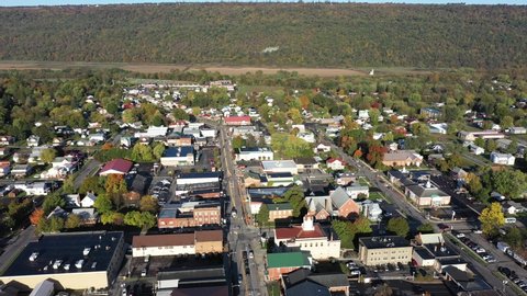 High aerial orbit around the city of Romney in Hampshire County, West Virginia in autumn.