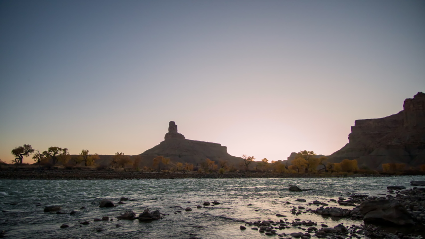 Timelapse as sunset turns to night looking over the Green River looking at Gunnison Butte in Utah.