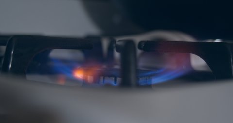 Stove top burner ignite blue flame.
Macro close up.