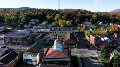 Aerial camera push in and pitch down onto the coupala dome of the Hampshire County Courthouse in Romney West Virginia in autumn.