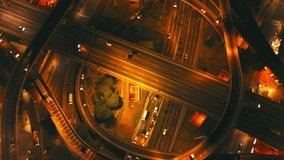 drone footage from a Highway crossing in Buenos Aires, at night. Nice contrast of street lights and shadows. Traffic moving. Slightly out of focus camera effect. Flying upwards.