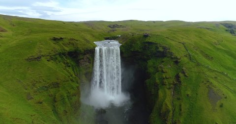 SEAMLESS LOOP VIDEO: Iceland Skogafoss waterfall. Aerial drone video of Icelandic landscape. Famous tourist attractions and landmarks destinations in Icelandic nature on Iceland. Looping 4K UHD video.