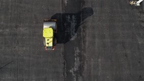 Aerial video of the road, construction vibration roller compactor lays the asphalt. Russia, St. Petersburg.