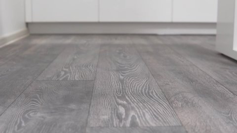 Closeup new laminate flooring on kitchen sliding sideways