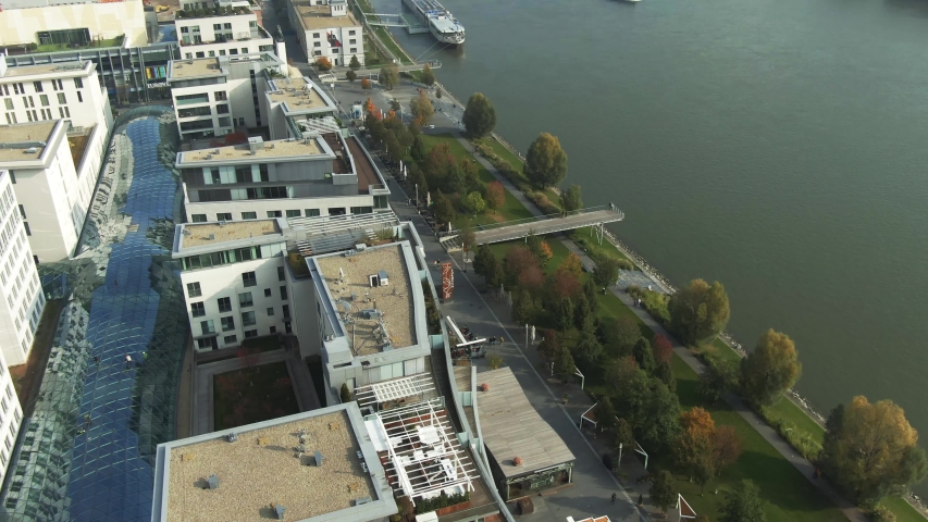 Aerial Shot of Commercial District, A Harbor And Apollo Bridge With a City Park Next to a Danube River In a Foggy Autumn Morning In Bratislava, Slovakia