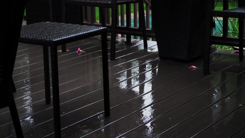 Static take of a gloomy evening rain in a suburban backyard. 4k footage taken at 24 frames per second.