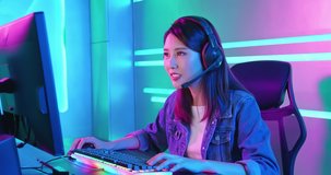 Young Asian Pretty Pro Gamer having live stream and playing in Online Video Game