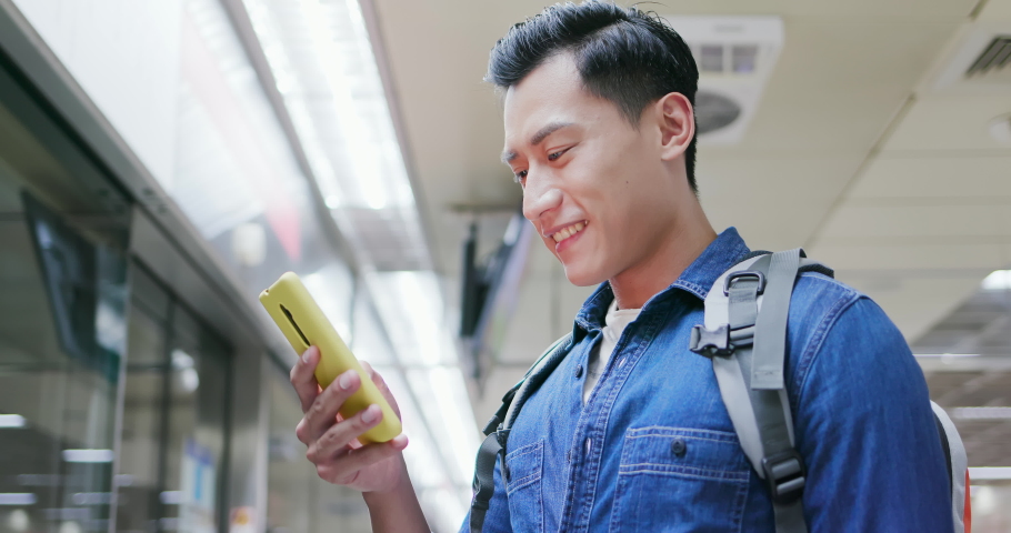asian young man use 5g smartphone on the mrt station Royalty-Free Stock Footage #1040269580