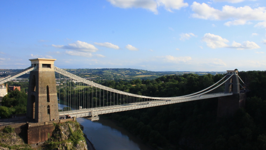 Time-lapse of Isambard Kingdom Brunel's suspension bridge in the city of Bristol , UK . With blue sky.