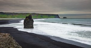 ICELAND TIMELAPSE LOOP VIDEO: Reynisfjara Beach view point Dyrholaey. Famous Iceland black sand beach on South Iceland. Icelandic nature landscape tourist attraction destination. 4K, available in 8K.