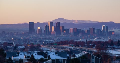 Sunrise over skyscrapers in downtown Denver on the background of Pikes Peak
