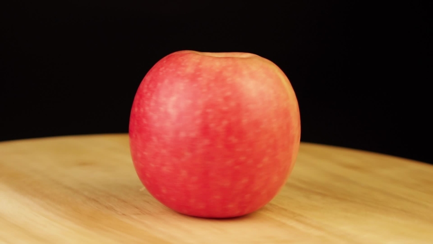 red Apple rotates 360 degrees on a wooden stand