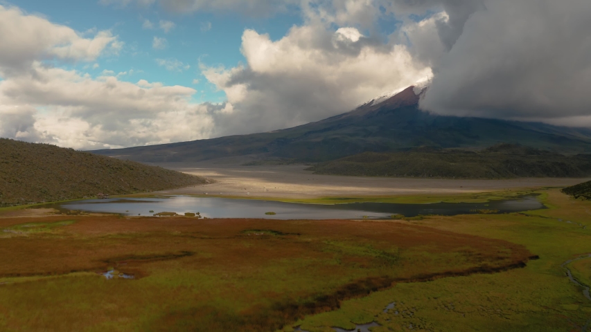 Cotopaxi plateau aerial drone view, peak hiding in the clouds, Limpiopungo lagoon below