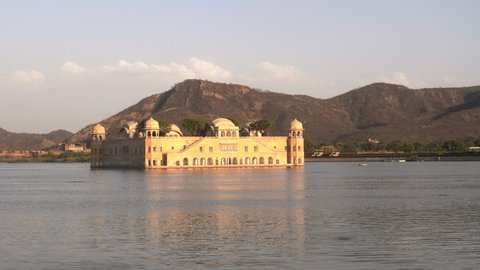 a sunset pan of jal mahal palace in lake man sagar at jaipur, india