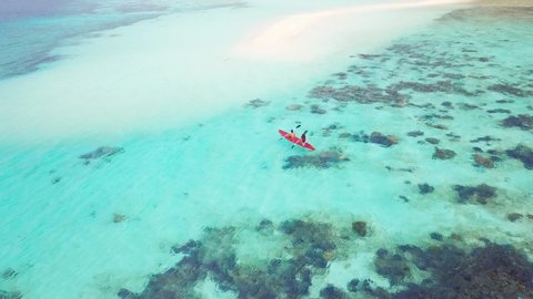 Kayak With Couple in Turquoise Water by Remote Tropical Philippines Island With White Beach Sand Bar and Coral Reef, Aerial