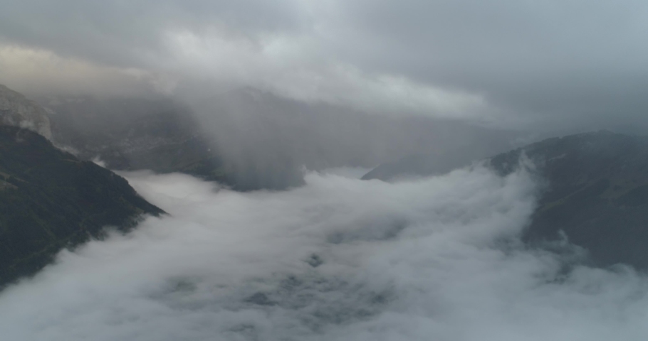 Flying over cloud in swiss montain in autumn