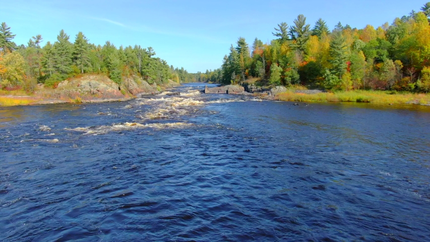 Scenic Autumn flight over Pemene Falls, Menominee River, Fall colors. The Menominee River flows along the border of Wisconsin and Upper Michigan.