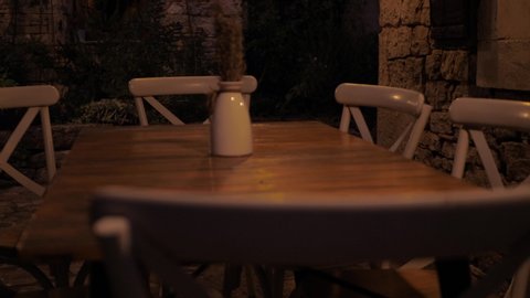 Wooden table and chairs in the evening mood in a  restaurant.