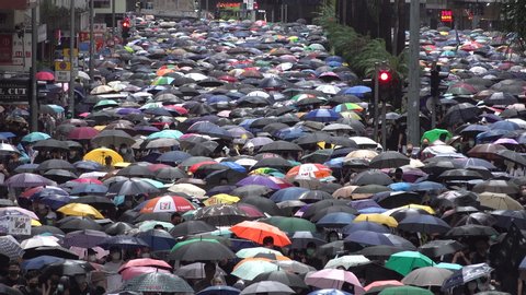 HONG KONG – 6 OCTOBER 2019: Spectacular view of crowds of protesters carrying umbrellas against the rain, during anti government demonstrations in Hong Kong, politics and activism in China