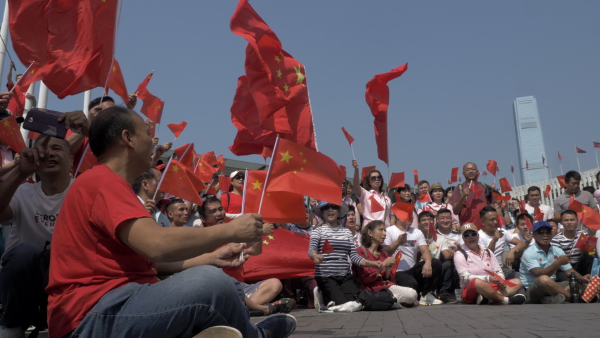 Hong Kong / China - 1 October 2019: Pro-Beijing tourist celebrating the National Day of the People