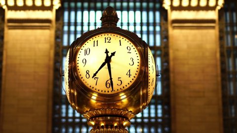 NEW YORK CITY, USA - OCT 17, 2019: Golden clock in Grand Central Station. Concept of NYC rush hour, urban commuter work lifestyle. Cinematic interior. Visit NYC.