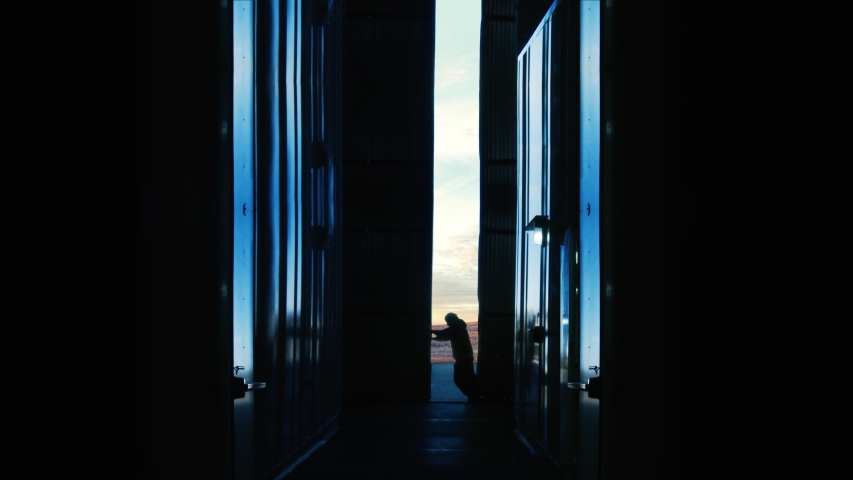 Industrial Warehouse Doors Opening at Sunrise With Worker Silhouette - 4K