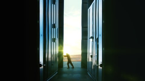 Man Opening Door of Container Warehouse at Sunset. Back to Work Concept. 