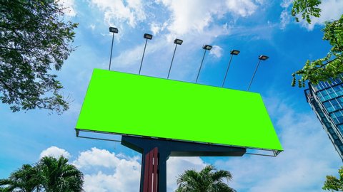 High-quality time-lapse day time video of a large green screen billboard on the street in Asia country for advertising video with chroma key.