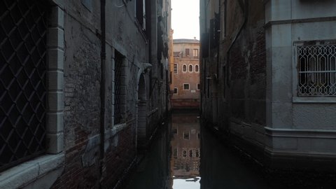 Small canal in Venice Castello district. Tracking POV shot