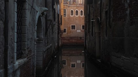 Small canal in Venice Castello district. Tracking POV shot.