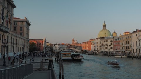4k Video. Tracking POV shot. Fantastic sunset in Venice with San Simeone Piccolo church. Boats and motorboats. Colorful sunset scene in Italy, Europe. 