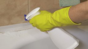 Woman using cleaning equipment for bathroom cleaning