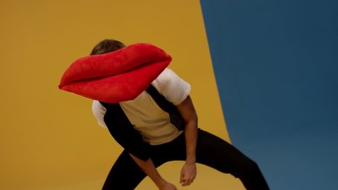 Male artist with a lip as a head making the different gesture and dancing , sending air kiss . Funny video of man, who move his body and head left to right . Shot on RED EPIC Cinema Camera .