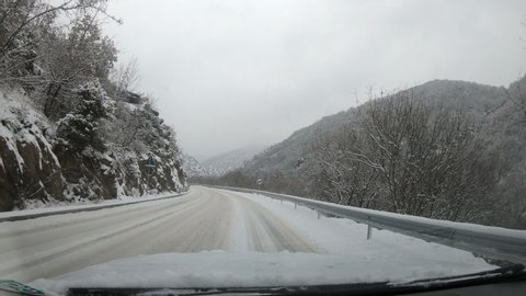 Scenic View Of A Road With Snow Covered Landscape While Snowing In Winter Season - Pov, First Person