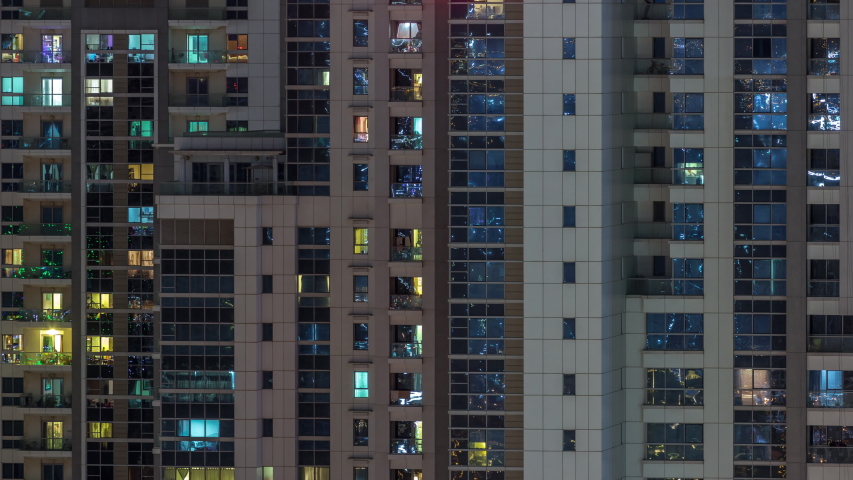 Lights from windows of offices and apartments aerial timelapse. Skyscrapers with working people in the evening in Business Bay, Dubai, United Arab Emirates. Complex of towers at night | Shutterstock HD Video #1040416883