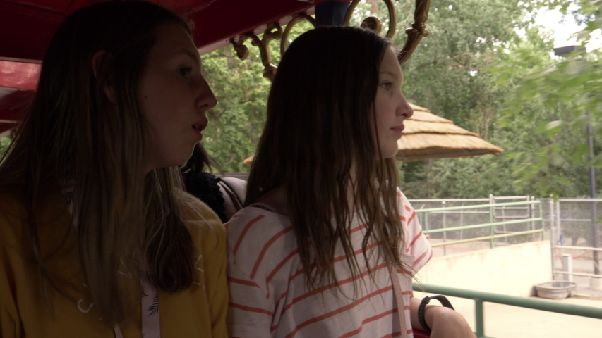 Smiling sightseeing girls photographing with cell phone / Kaysville, Utah, United States