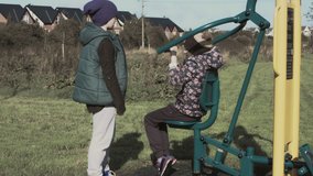 4k Outdoor Shot of Children Working out Outside with Gym Equipment