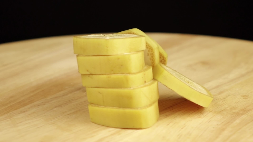sliced banana rotates 360 degrees on wooden platform