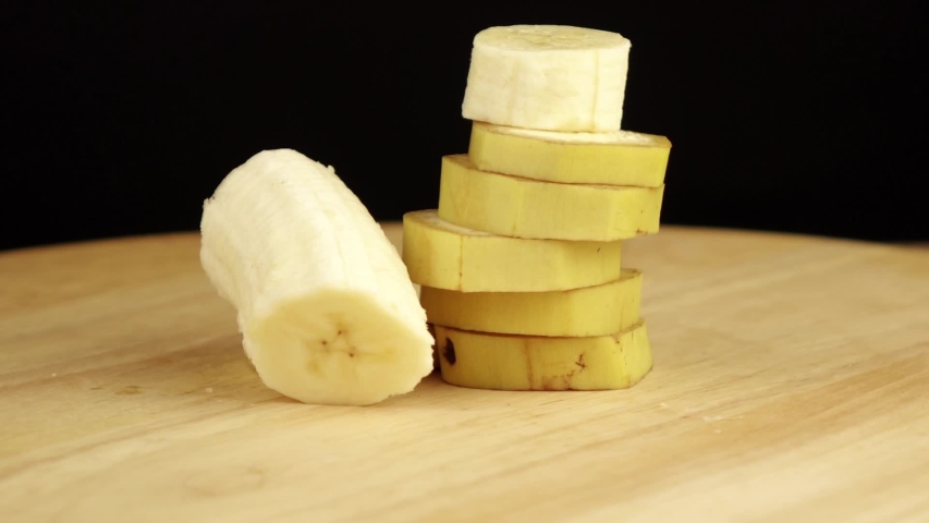 sliced banana rotates 360 degrees on wooden platform