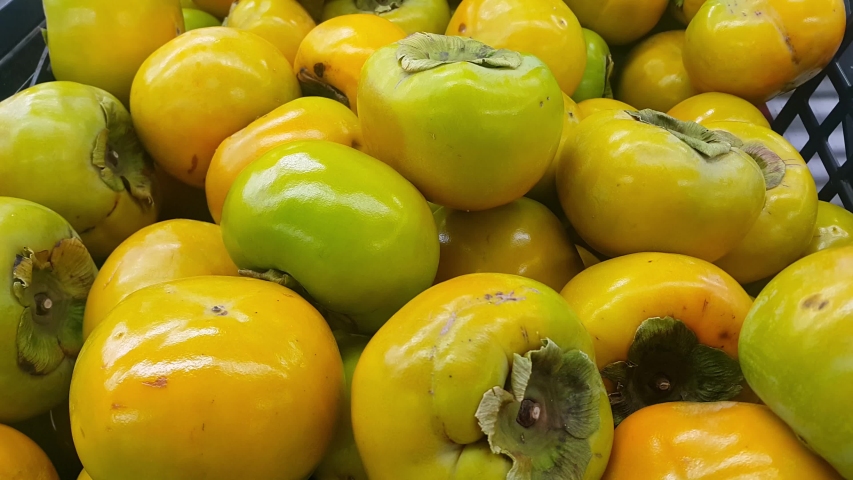 4K close up view of fresh picked red honey juicy Japanese fruit or amlok in the harvest season placed in a market or bazaar for sale. Food background