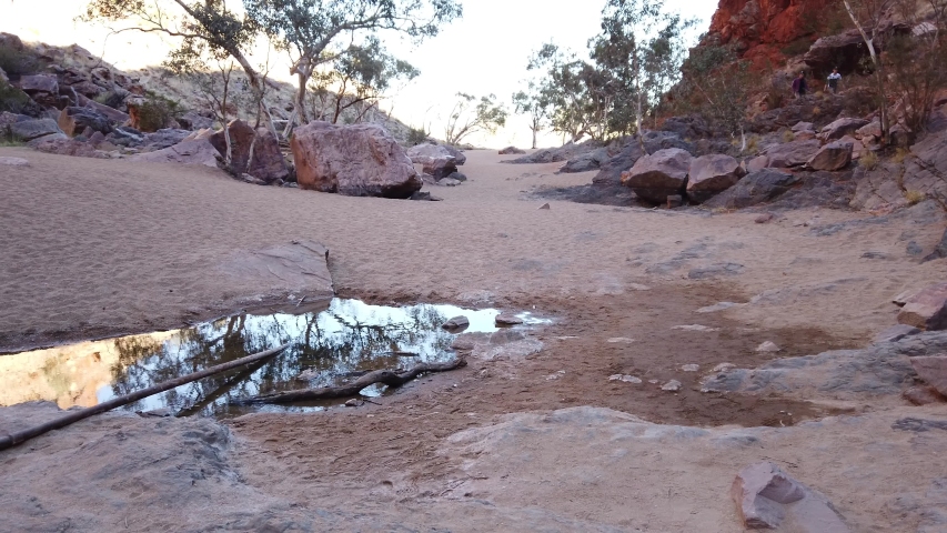 Simpsons Gap reflected in permanent waterhole in West MacDonnell National Park, Northern Territory near Alice Springs on Larapinta Trail in Central Australia. Popular landmark in Australian outback.